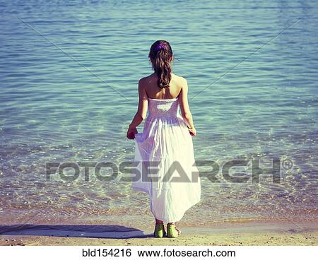 Caucasian girl wearing white dress on beach View Large Photo Image Stock Photograph - Caucasian girl wearing white dress on beach. Fotosearch