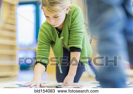Stock Image - Caucasian girl working in classroom. Fotosearch