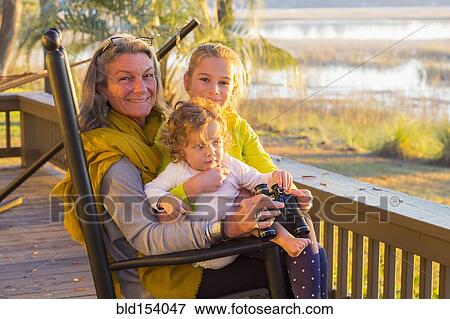 Caucasian grandmother and grandchildren using binoculars on porch View Large Photo Image Stock Photo - Caucasian grandmother and grandchildren using binoculars on porch. Fotosearch