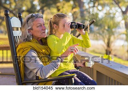 Caucasian grandmother and granddaughter using binoculars on porch View Large Photo Image Stock Photography - Caucasian grandmother and granddaughter using binoculars on porch. Fotosearch