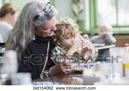 Caucasian grandmother and grandson eating dinner in restaurant View Large Photo Image Stock Image - Caucasian grandmother and grandson eating dinner in restaurant. Fotosearch
