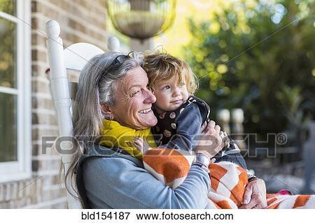 Caucasian grandmother and grandson sitting on porch View Large Photo Image Stock Photo - Caucasian grandmother and grandson sitting on porch. Fotosearch