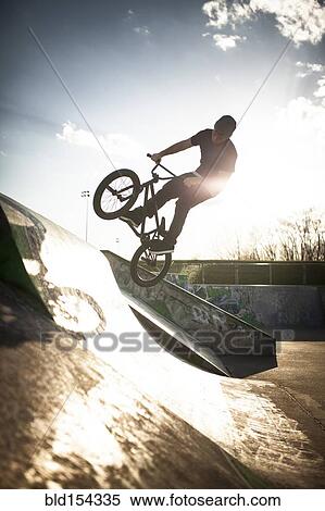 Caucasian man riding BMX bicycle at skate park View Large Photo Image Stock Photography - Caucasian man riding BMX bicycle at skate park. Fotosearch
