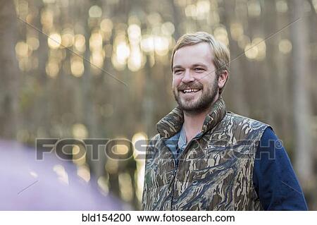 Caucasian man wearing camouflage vest outdoors View Large Photo Image Stock Image - Caucasian man wearing camouflage vest outdoors. Fotosearch