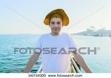 Caucasian man wearing sun hat on pier View Large Photo Image Stock Image - Caucasian man wearing sun hat on pier. Fotosearch