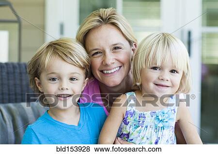 Stock Photo - Caucasian mother and children smiling outdoors. Fotosearch