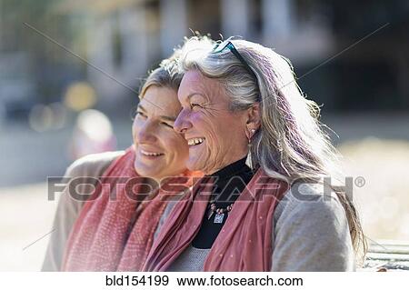 Caucasian mother and daughter sitting outdoors View Large Photo Image Stock Photo - Caucasian mother and daughter sitting outdoors. Fotosearch