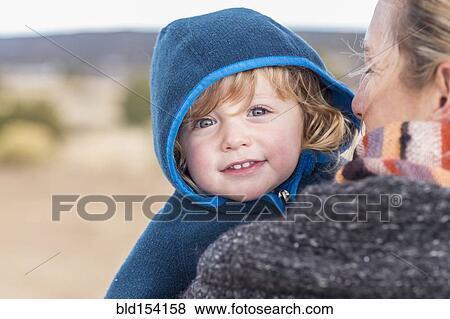 Stock Photo - Caucasian mother carrying baby boy. Fotosearch