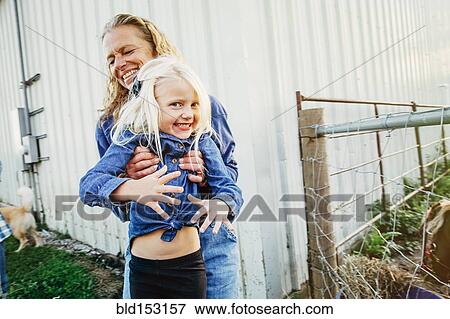 Caucasian mother playing with daughter on farm View Large Photo Image Stock Photo - Caucasian mother playing with daughter on farm. Fotosearch