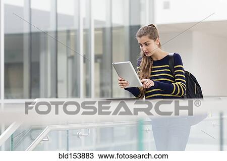 Stock Image - Caucasian student using digital tablet on campus. Fotosearch