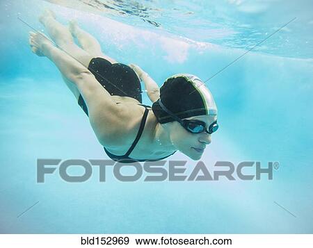 Caucasian swimmer diving into swimming pool View Large Photo Image Stock Photo - Caucasian swimmer diving into swimming pool. Fotosearch