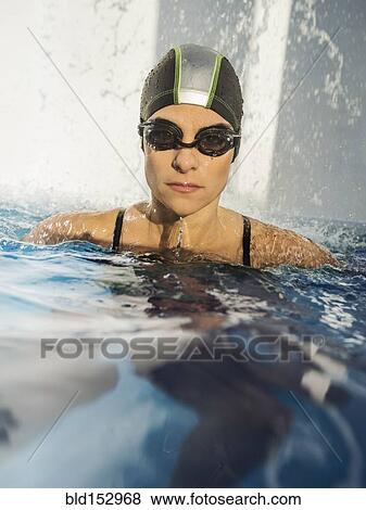 Stock Photo - Caucasian swimmer with swimming cap in swimming pool. Fotosearch