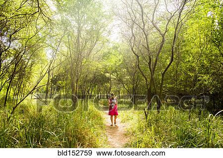 Caucasian woman carrying baby in lush jungle View Large Photo Image Stock Photo - Caucasian woman carrying baby in lush jungle. Fotosearch