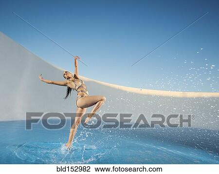 Caucasian woman dancing on swimming pool View Large Photo Image Stock Image - Caucasian woman dancing on swimming pool. Fotosearch