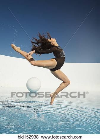 Stock Photo - Caucasian woman dancing on water surface. Fotosearch