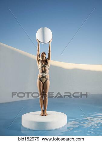 Caucasian woman holding sphere on ice floe View Large Photo Image Stock Photo - Caucasian woman holding sphere on ice floe. Fotosearch