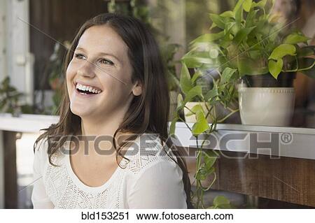 Stock Image - Caucasian woman laughing outdoors. Fotosearch