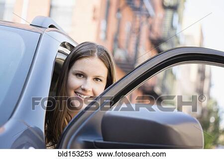 Caucasian woman opening car door View Large Photo Image Stock Image - Caucasian woman opening car door. Fotosearch
