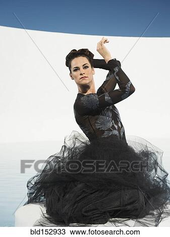 Caucasian woman posing in evening gown View Large Photo Image Stock Image - Caucasian woman posing in evening gown. Fotosearch