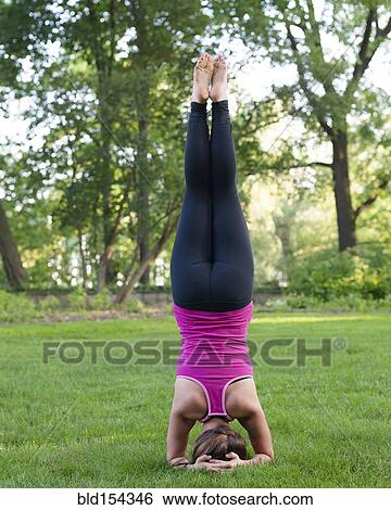 Caucasian woman practicing yoga in park View Large Photo Image Stock Photograph - Caucasian woman practicing yoga in park. Fotosearch