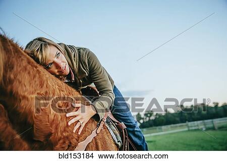Caucasian woman riding horse on ranch View Large Photo Image Picture - Caucasian woman riding horse on ranch. Fotosearch