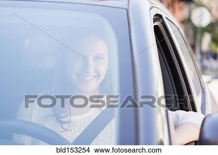Picture - Caucasian woman smiling in car. Fotosearch