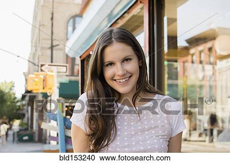 Caucasian woman smiling on urban sidewalk View Large Photo Image Stock Image - Caucasian woman smiling on urban sidewalk. Fotosearch