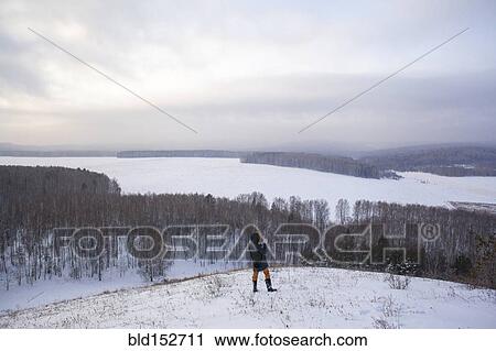 Caucasian woman standing on snowy hilltop View Large Photo Image Stock Image - Caucasian woman standing on snowy hilltop. Fotosearch