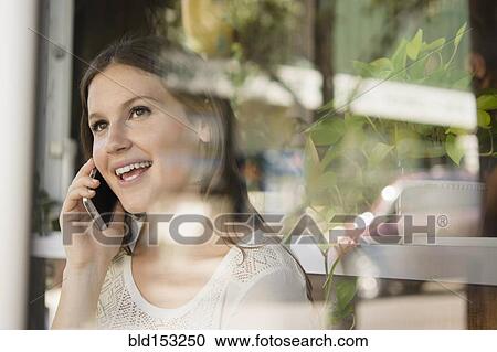 Stock Image - Caucasian woman talking on cell phone. Fotosearch