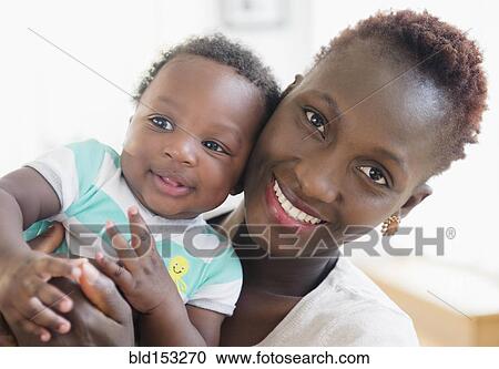 Stock Image - Close up of Black mother and son smiling. Fotosearch