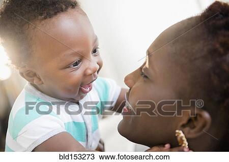 Stock Image - Close up of Black mother and son smiling. Fotosearch