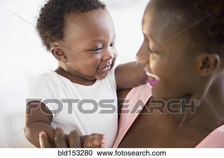 Stock Image - Close up of Black mother and son smiling. Fotosearch