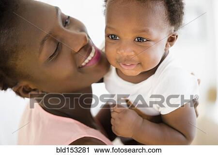 Stock Image - Close up of Black mother and son smiling. Fotosearch