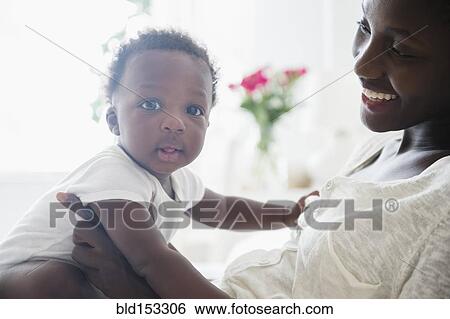 Close up of Black mother holding baby boy View Large Photo Image Stock Photograph - Close up of Black mother holding baby boy. Fotosearch