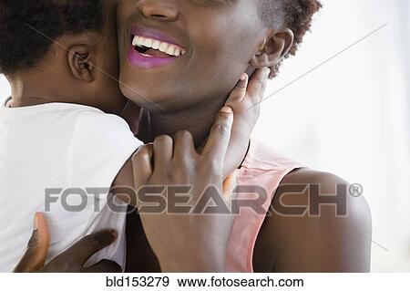 Close up of Black mother holding son View Large Photo Image Stock Photo - Close up of Black mother holding son . Fotosearch