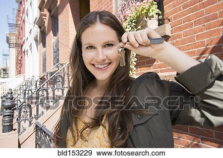 Stock Photo - Close up of Caucasian woman holding keys to new house. Fotosearch