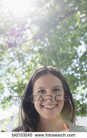 Stock Photography - Close up of Caucasian woman smiling outdoors. Fotosearch