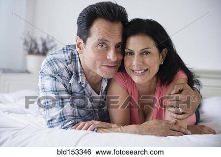 Close up of couple hugging on bed View Large Photo Image Stock Photograph - Close up of couple hugging on bed. Fotosearch