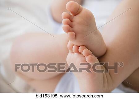 Stock Photography - Close up of feet of mixed race baby. Fotosearch