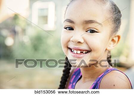 Close up of mixed race girl smiling View Large Photo Image Stock Photograph - Close up of mixed race girl smiling. Fotosearch