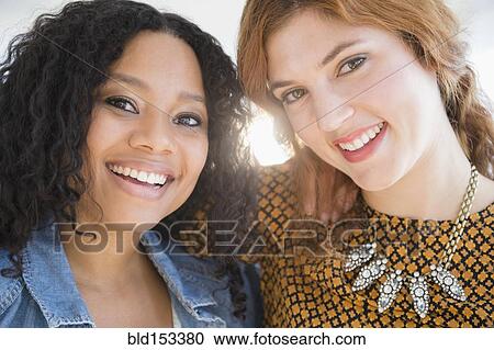 Close up of smiling women hugging View Large Photo Image Stock Image - Close up of smiling women hugging. Fotosearch