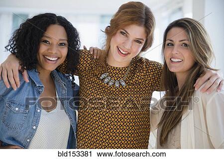 Close up of smiling women hugging View Large Photo Image Stock Image - Close up of smiling women hugging. Fotosearch