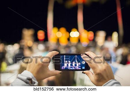 Close up of woman photographing hula dancers at luau View Large Photo Image Stock Photograph - Close up of woman photographing hula dancers at luau. Fotosearch