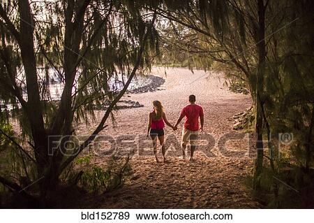 Stock Photo - Couple holding hands on beach. Fotosearch