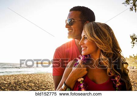 Stock Photography - Couple hugging on tropical beach. Fotosearch