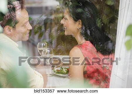 Stock Photo - Couple talking in restaurant. Fotosearch