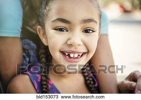Stock Image - Daughter and mother smiling outdoors. Fotosearch