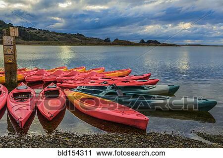Stock Image - Empty canoes on calm remote lake. Fotosearch