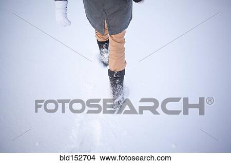 High angle view of Caucasian woman walking in snowy field View Large Photo Image Picture - High angle view of Caucasian woman walking in snowy field. Fotosearch