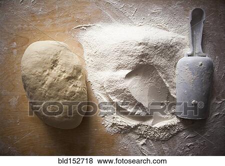 Stock Photo - High angle view of flour and dough on table. Fotosearch
